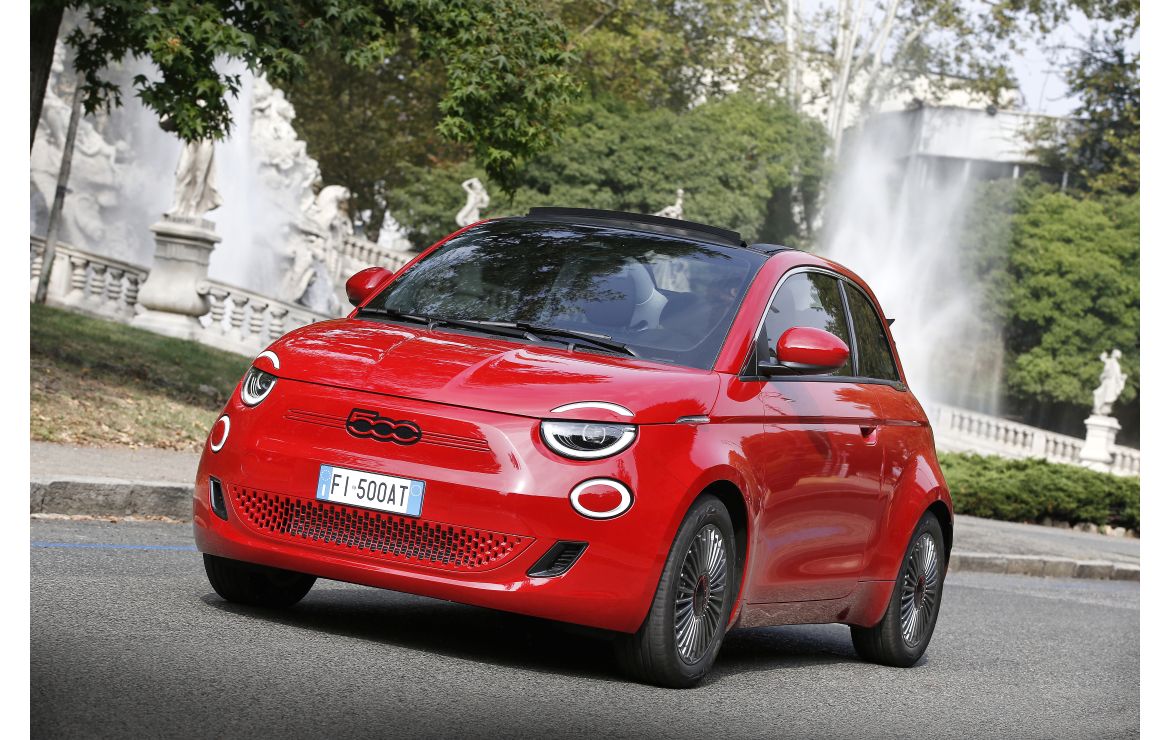 Red Fiat 500 cabriolet on a European city street