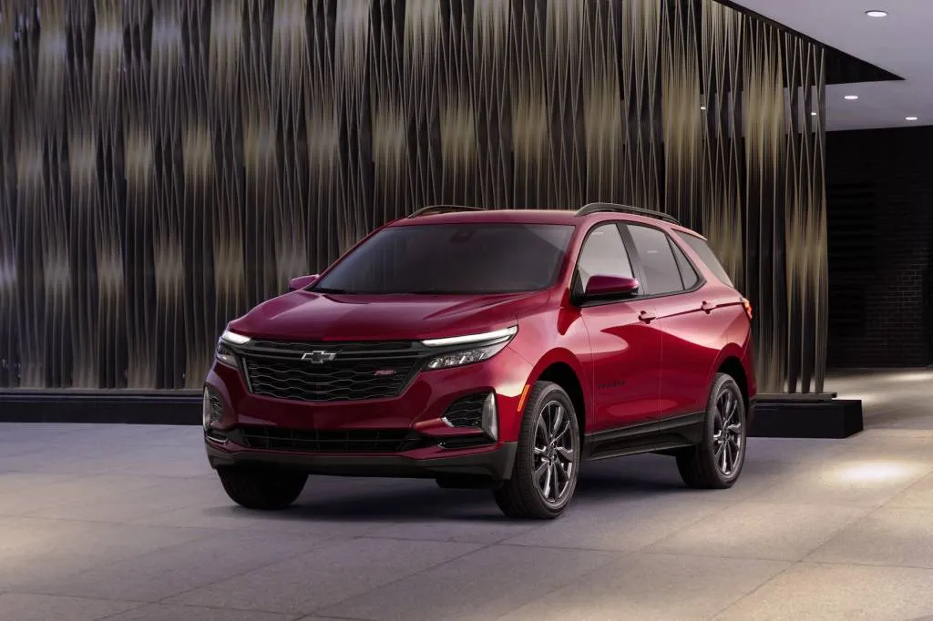 2024 Chevrolet Equinox RS in Radiant Red Tintcoat front three-quarter view showing blacked-out RS styling