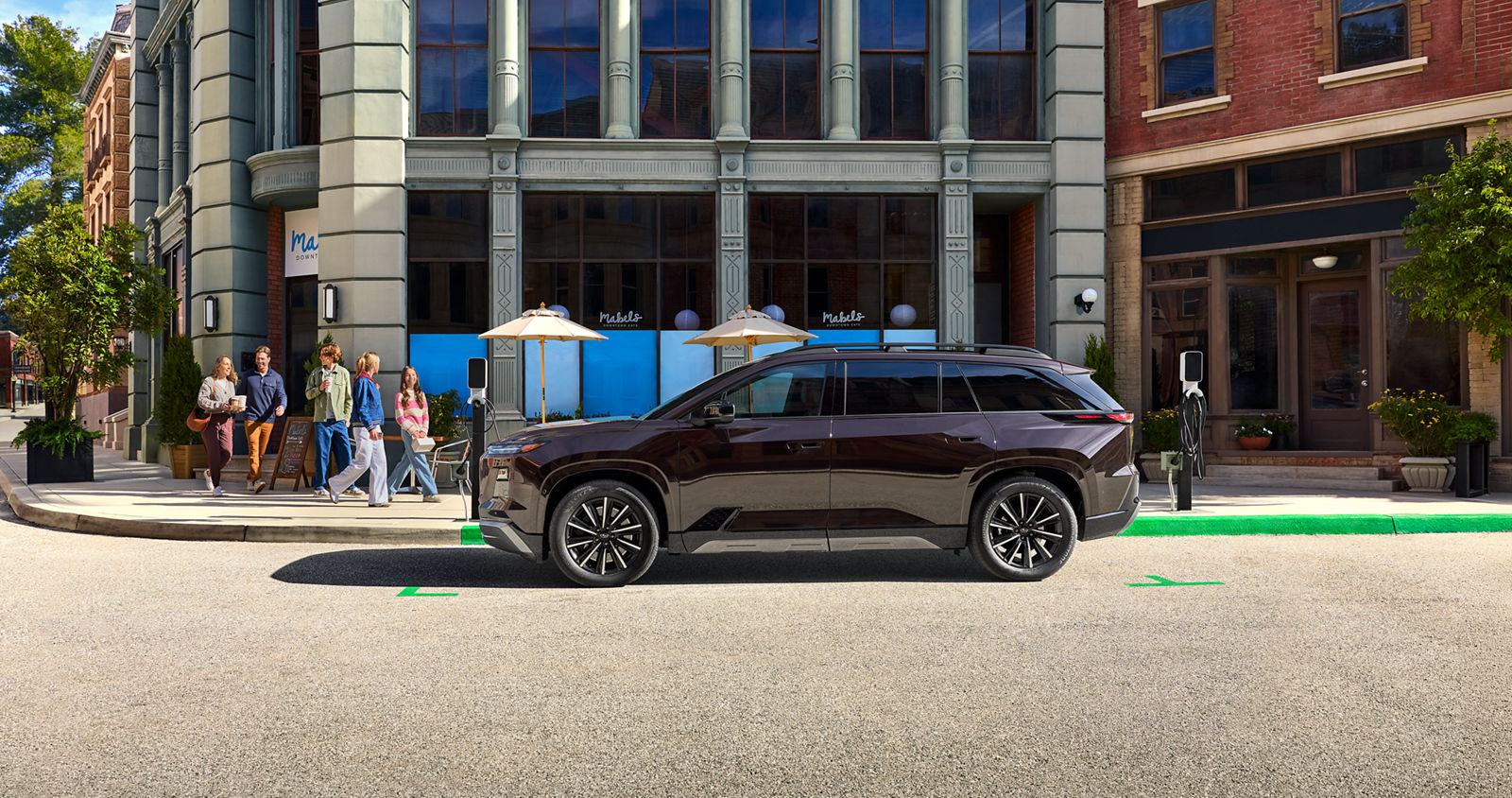 Official Subaru image of the 2027 Getaway parked in an urban setting near a coffee shop