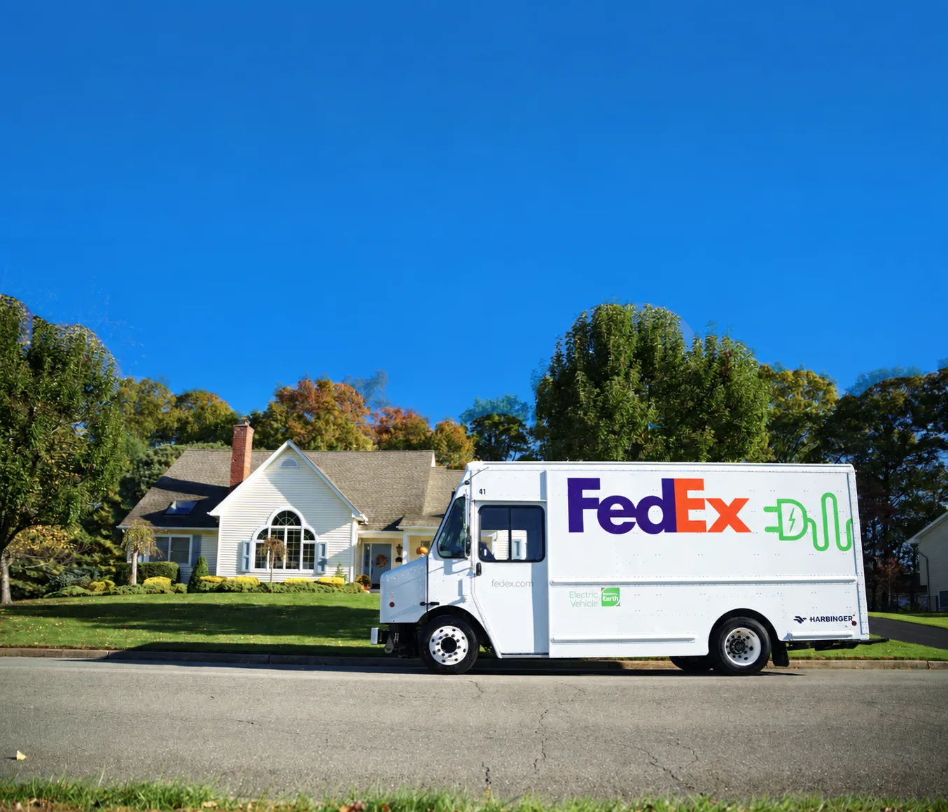 Official Harbinger photo of a white FedEx electric delivery truck on a residential street