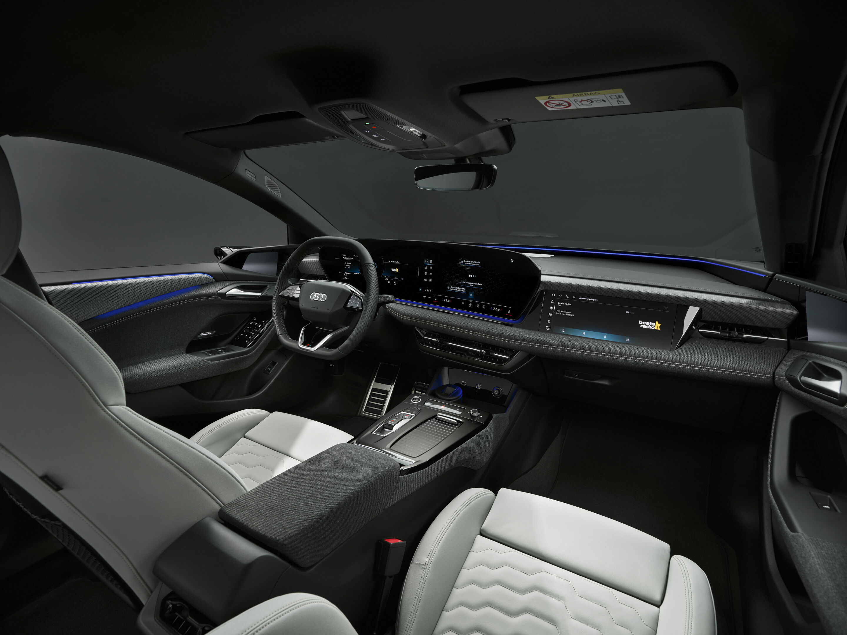 Audi A6 e-tron official interior image showing the dashboard, steering wheel, and front seats