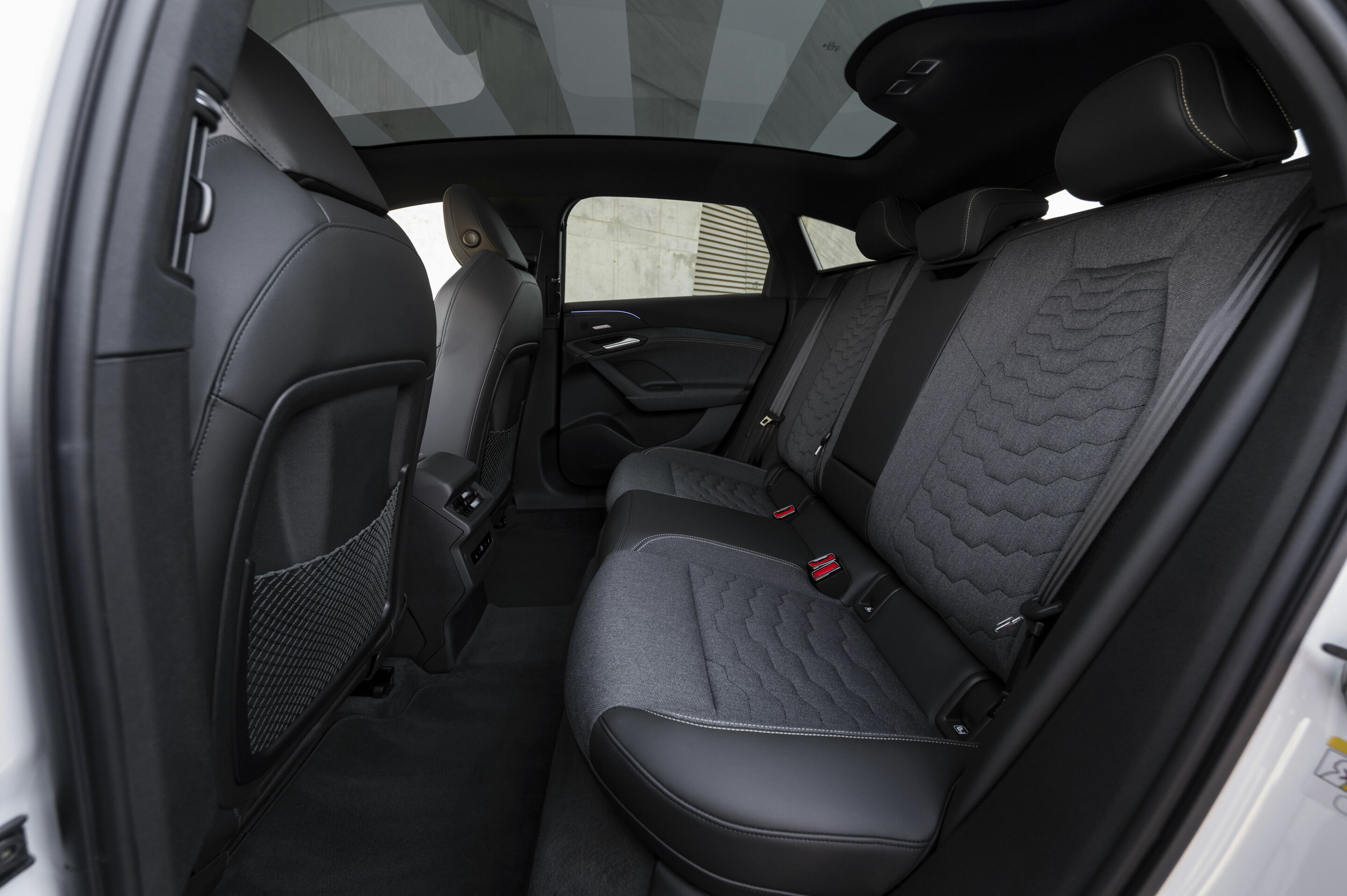 Audi A6 e-tron official rear-seat image with panoramic glass roof