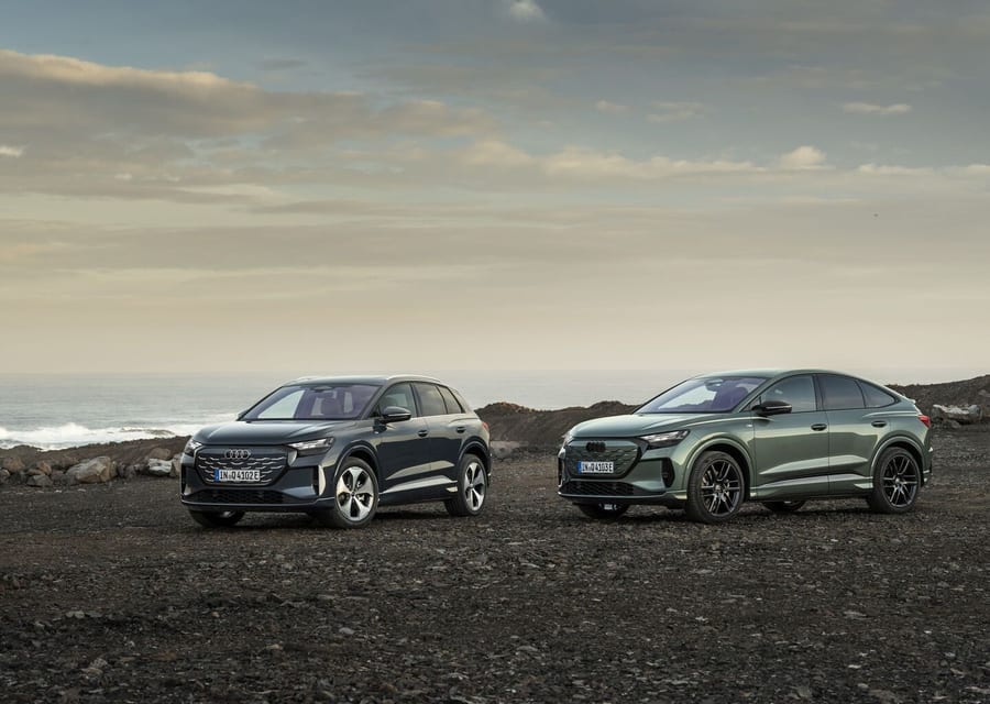 Audi Q4 SUV e-tron and Q4 Sportback e-tron parked together on rocky terrain