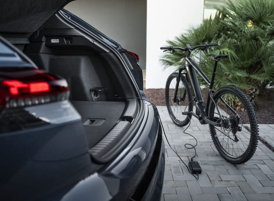 Audi Q4 SUV e-tron trunk power outlet charging an e-bike