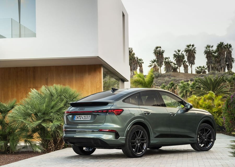 Audi Q4 Sportback e-tron rear three-quarter view outside a modern home