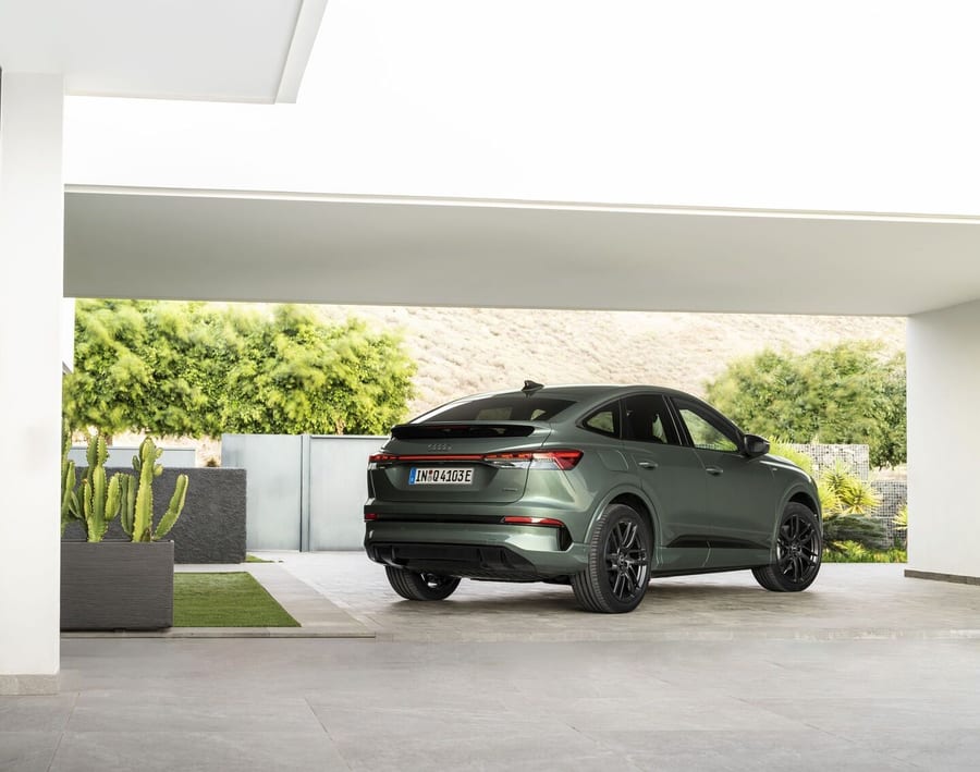 Audi Q4 Sportback e-tron rear three-quarter view under a modern overhang