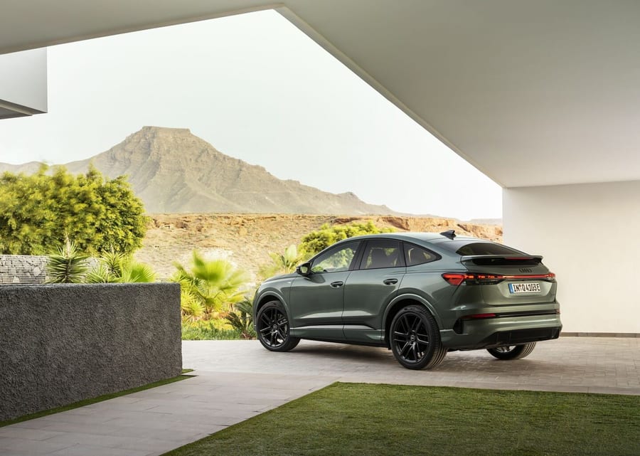 Audi Q4 Sportback e-tron side profile outside a modern building