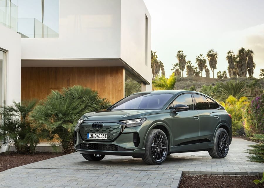 Audi Q4 Sportback e-tron front three-quarter view outside a modern home