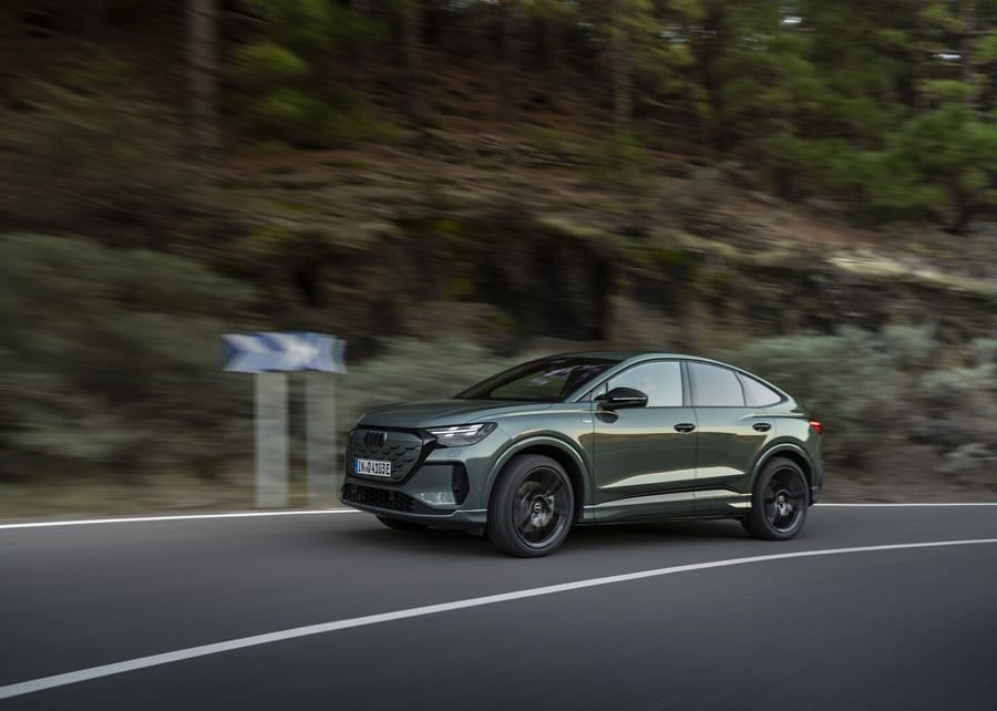 Audi Q4 Sportback e-tron driving on a curving forest road