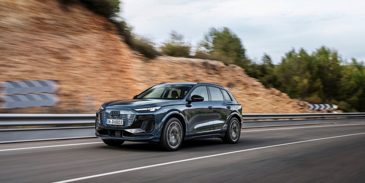 2026 Audi Q6 e-tron quattro electric SUV on a scenic road, showcasing its sleek PPE-platform design