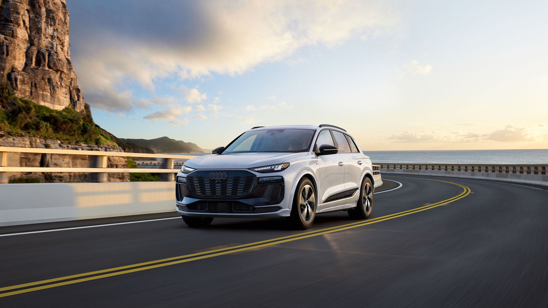 2027 Audi Q6 e-tron official front three-quarter driving image