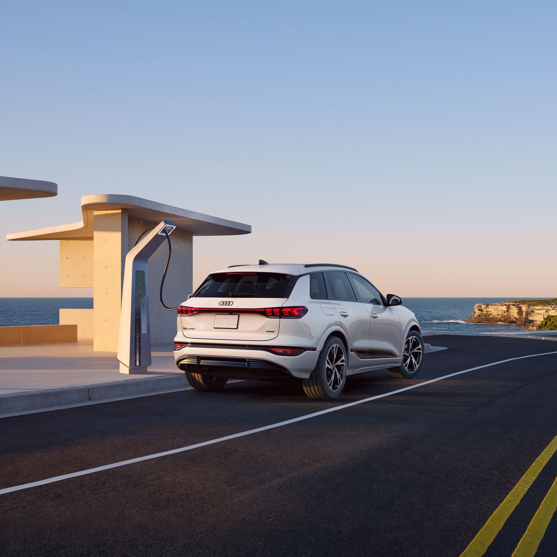 2027 Audi Q6 e-tron official rear three-quarter charging image