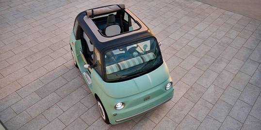 Official Fiat USA image of a mint green Fiat Topolino Dolcevita parked near a modern home