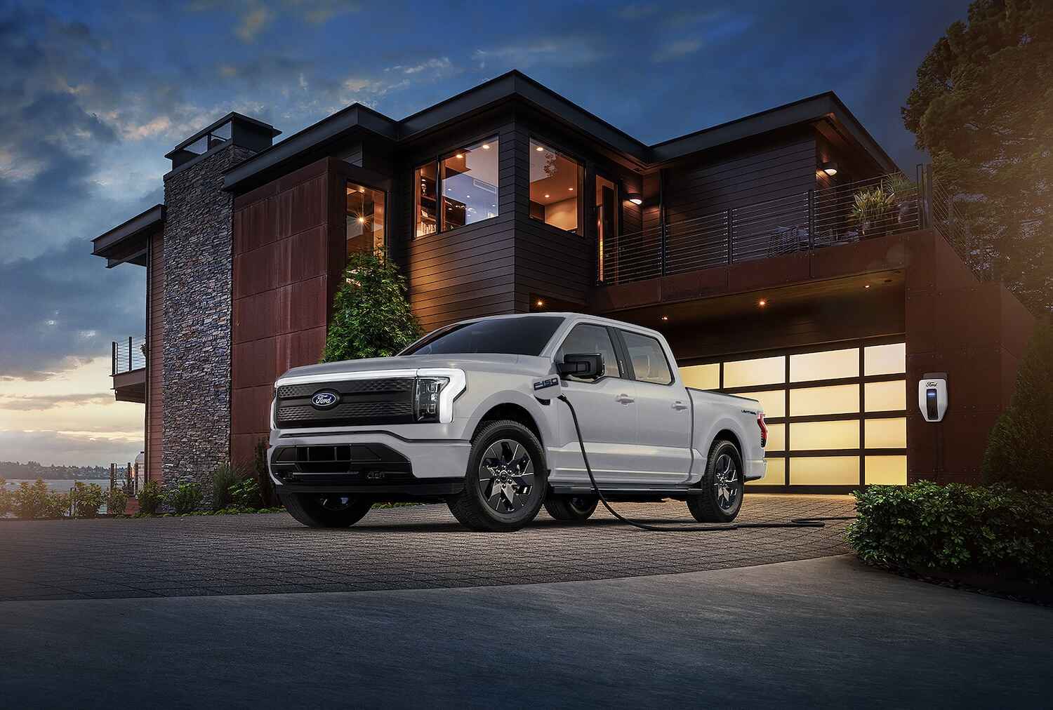 Ford F-150 Lightning electric pickup truck charging at a public charging station