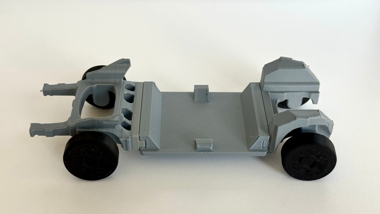 Close-up of a 3D-printed Ford Universal EV chassis model with exposed structure and wheels