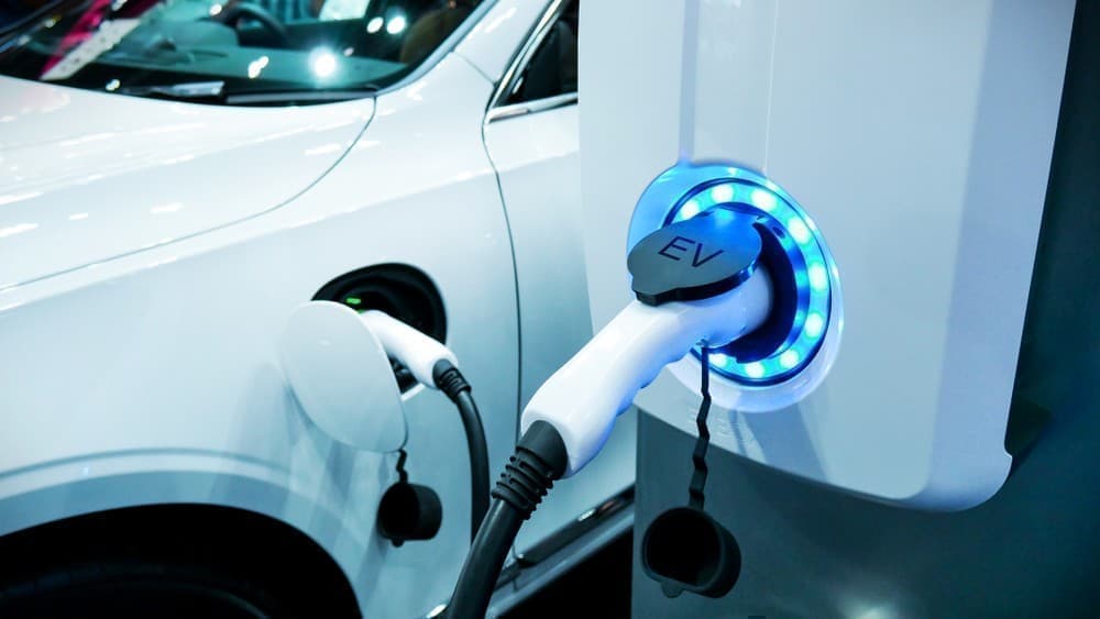 Electric vehicle dealership lot with sparse customer traffic