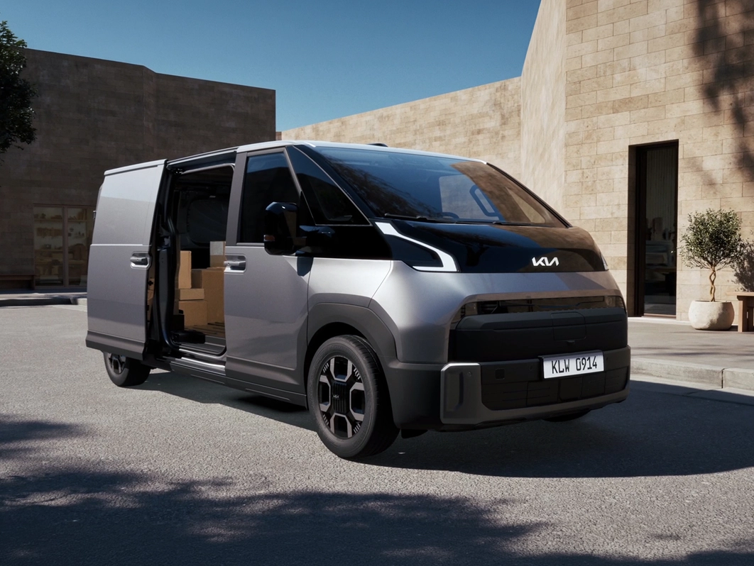 Official Kia image of the PV7 Cargo electric van with its sliding door open and boxes inside