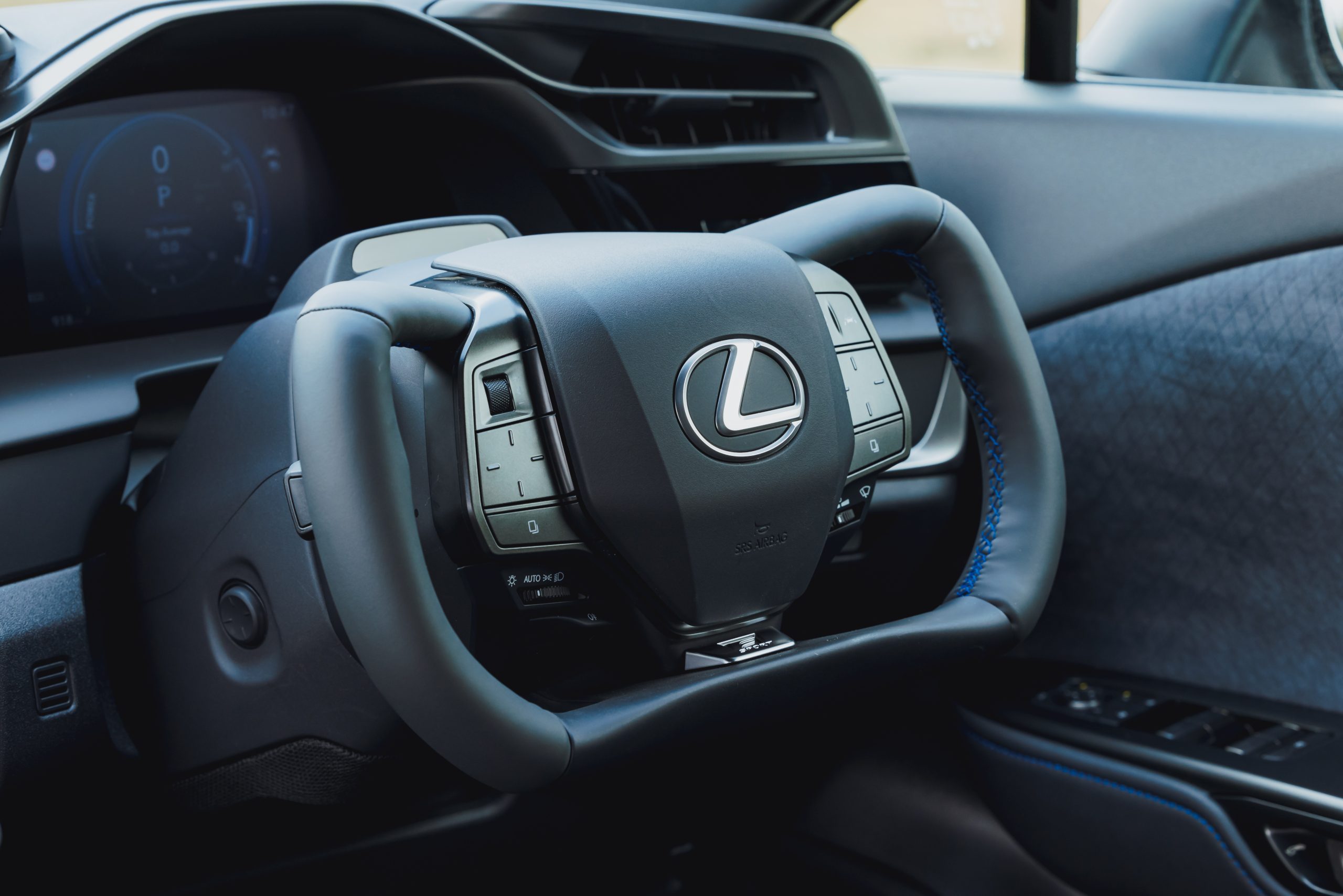 Close view of the Lexus RZ steer-by-wire yoke and digital instrument display