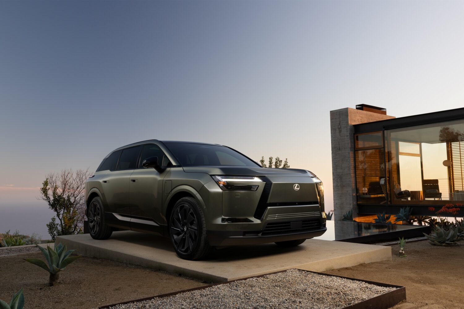 2027 Lexus TZ parked outside a modern home at dusk