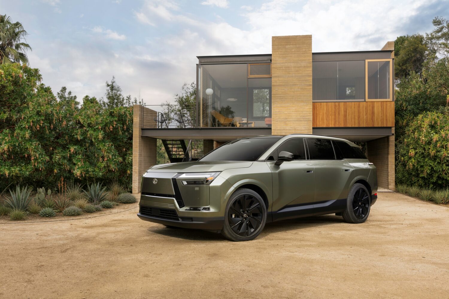 2027 Lexus TZ outside a modern house in a desert landscape