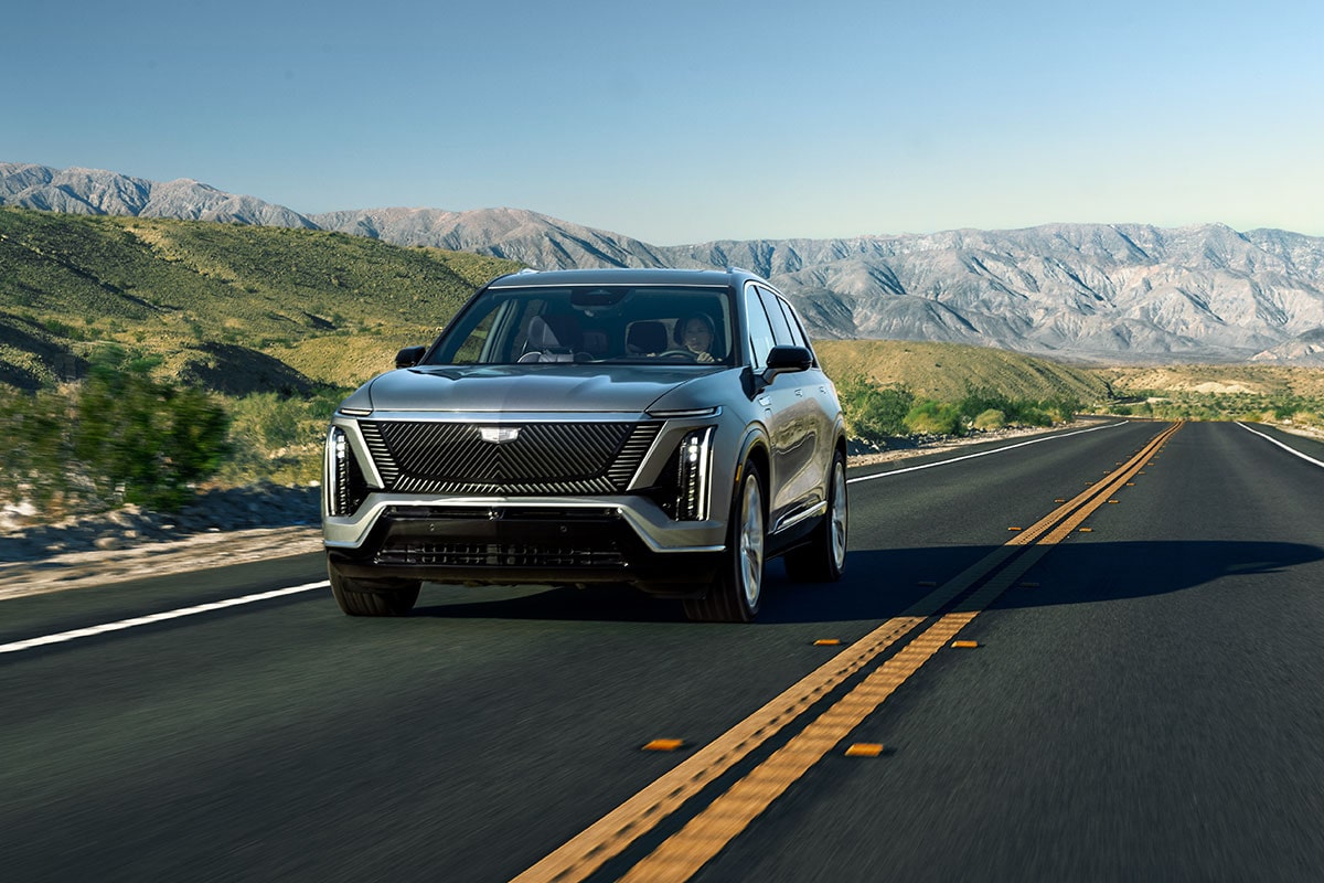 2026 Cadillac VISTIQ electric SUV driving on a mountain road