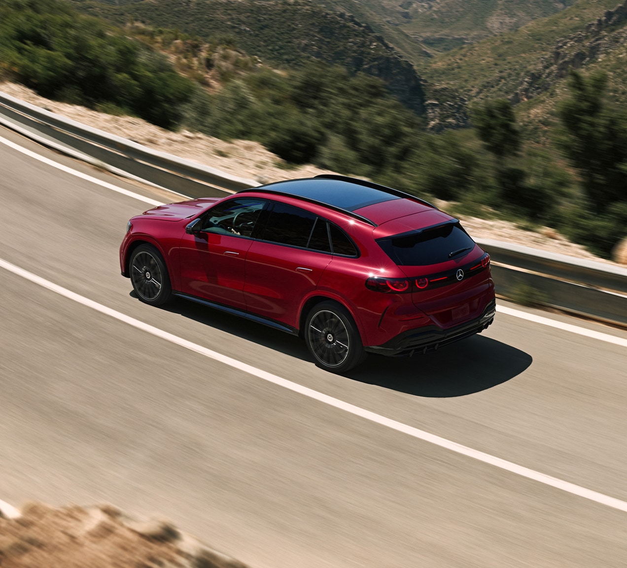 Official Mercedes-Benz image of a red 2027 GLC Electric driving on a mountain road